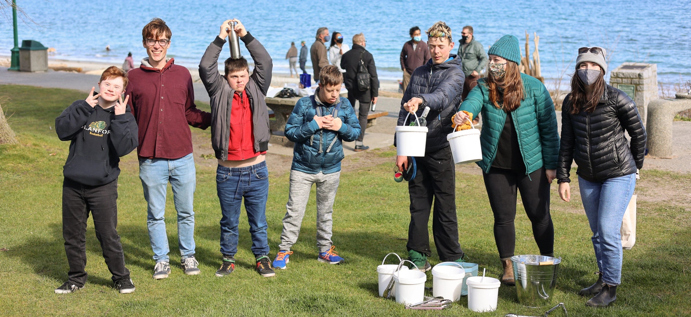 Nature Bee partners with local organizations to give back through community events and donations. Picture includes the nature bee team and members of the community outdoors doing a beach clean up.