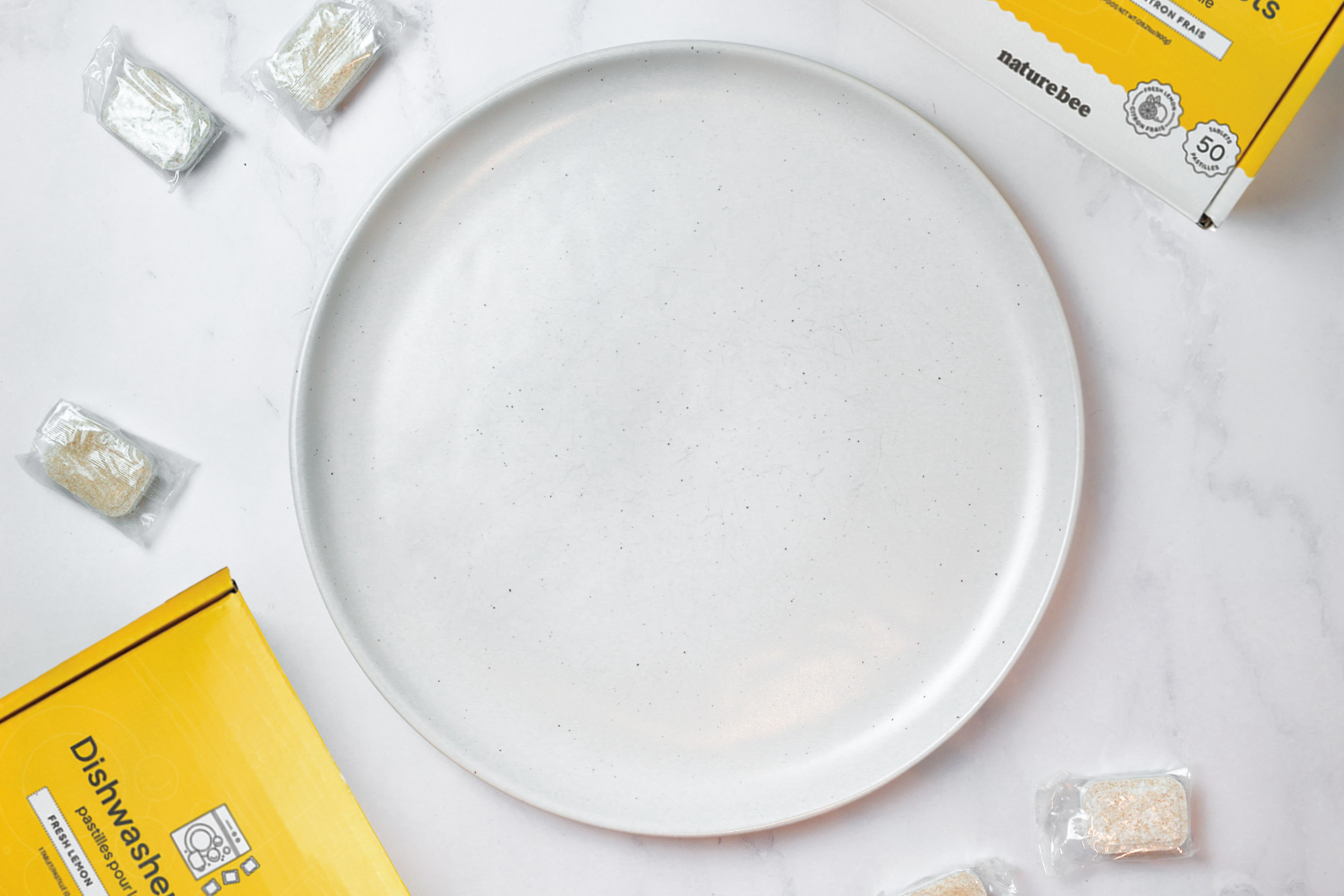 Comparison image two: after using Nature Bee dishwasher tablets, the plate is stain free, sparkling, and bright white.
